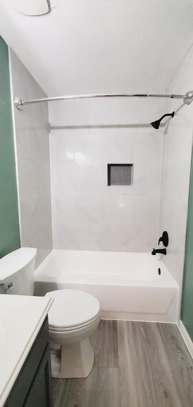 full bathroom featuring bathtub / shower combination, vanity, toilet, and wood finished floors