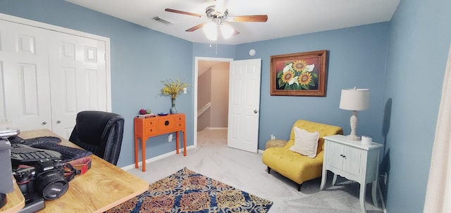 carpeted home office with baseboards, visible vents, and a ceiling fan