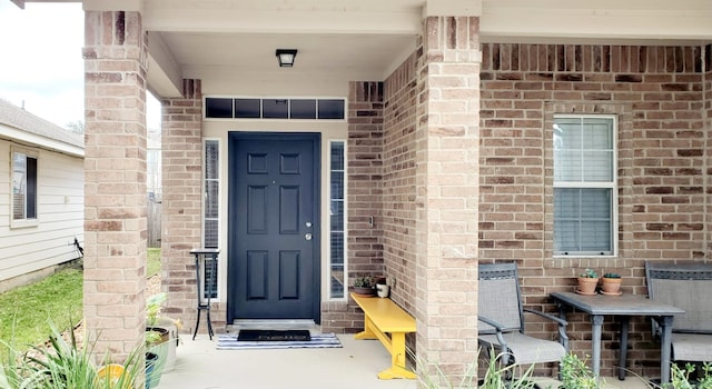 doorway to property featuring brick siding