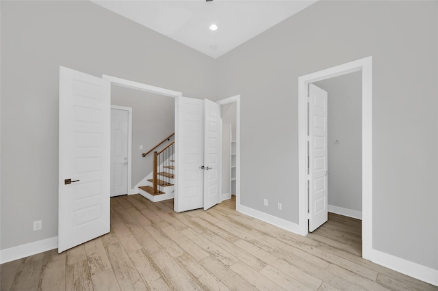 unfurnished bedroom featuring recessed lighting, baseboards, and wood finished floors