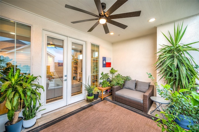 property entrance with french doors, a ceiling fan, and stucco siding