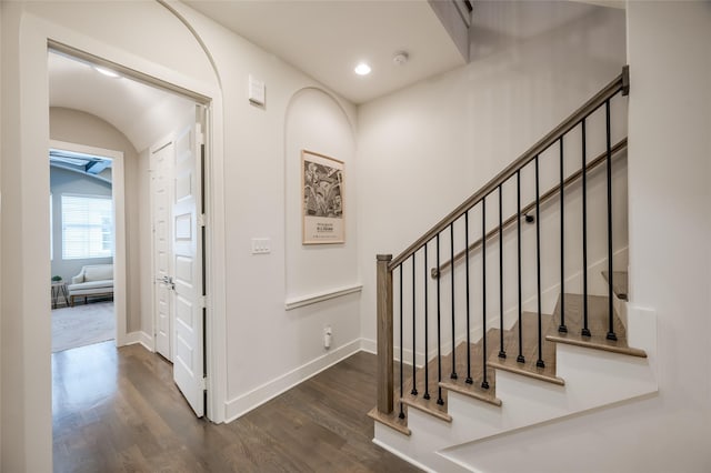 staircase featuring recessed lighting, baseboards, and wood finished floors