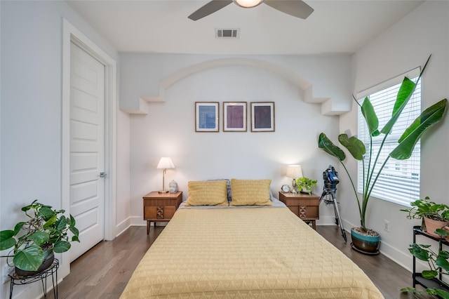 bedroom featuring dark wood-style floors, multiple windows, and visible vents