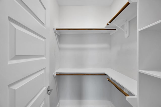 spacious closet featuring built in desk