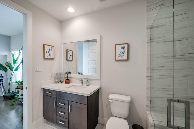 full bath with toilet, recessed lighting, vanity, baseboards, and walk in shower