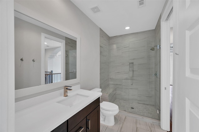 full bathroom featuring toilet, a stall shower, vanity, and visible vents