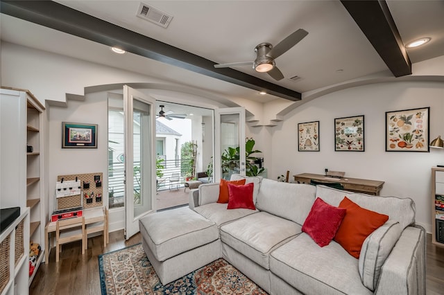 living area with ceiling fan, dark wood-type flooring, beamed ceiling, and visible vents