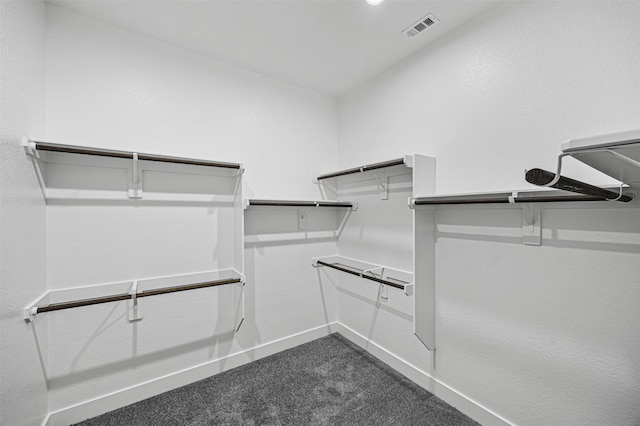 spacious closet featuring visible vents and dark carpet