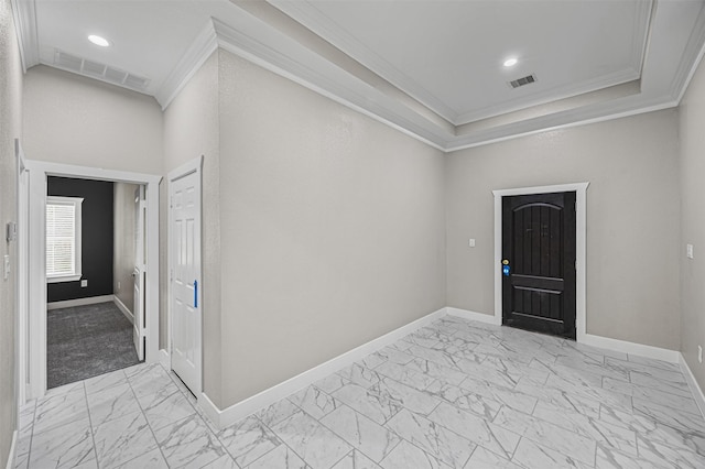 entryway featuring marble finish floor, ornamental molding, visible vents, and baseboards