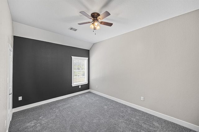 unfurnished room with ceiling fan, carpet flooring, visible vents, baseboards, and vaulted ceiling