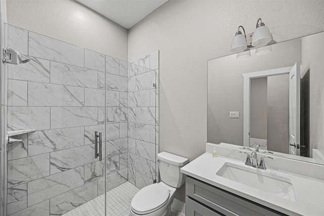 full bath featuring a textured wall, vanity, toilet, and a shower stall