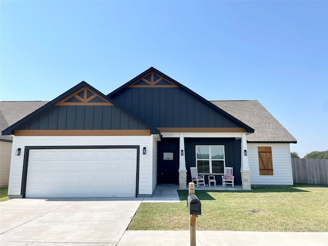 modern farmhouse featuring a shingled roof, fence, a front lawn, a porch, and board and batten siding