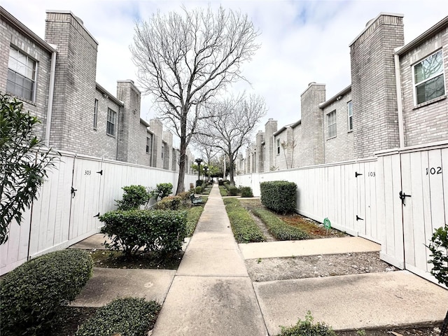 view of property's community featuring a residential view and fence