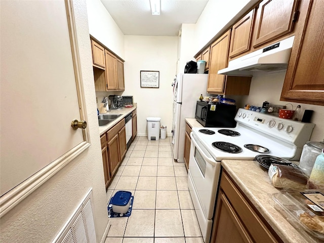 kitchen with light tile patterned floors, visible vents, light countertops, white appliances, and under cabinet range hood