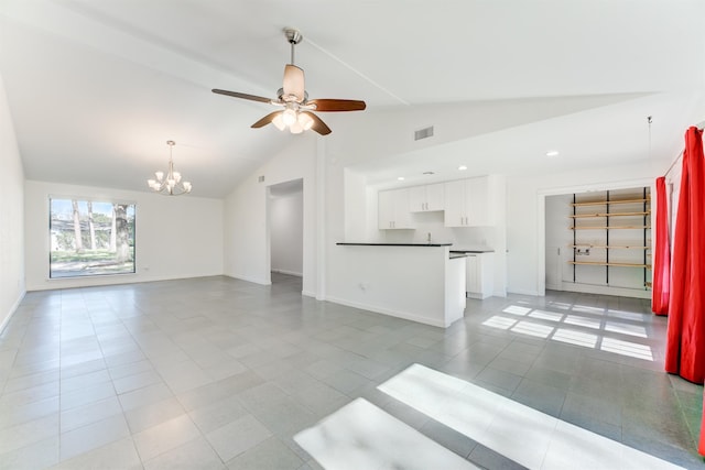 unfurnished living room with ceiling fan with notable chandelier, visible vents, and baseboards