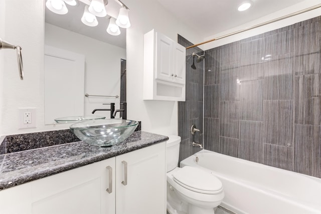 full bathroom featuring bathtub / shower combination, vanity, and toilet