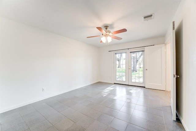 empty room featuring ceiling fan, french doors, visible vents, and baseboards