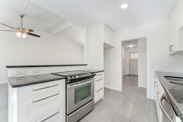 kitchen with appliances with stainless steel finishes, a ceiling fan, white cabinets, dark stone countertops, and baseboards