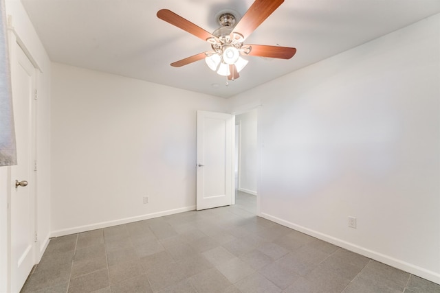 empty room featuring a ceiling fan and baseboards