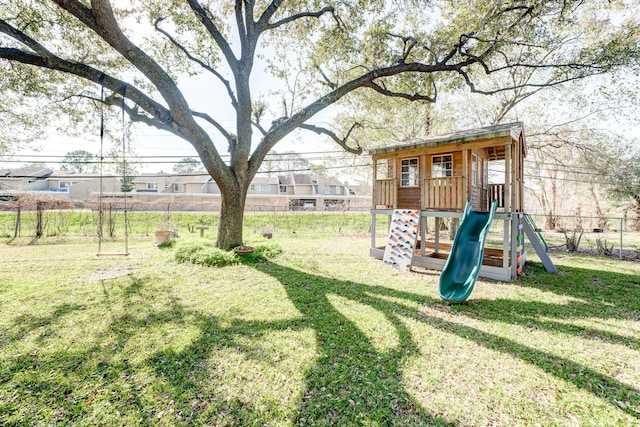 view of yard featuring a playground and fence