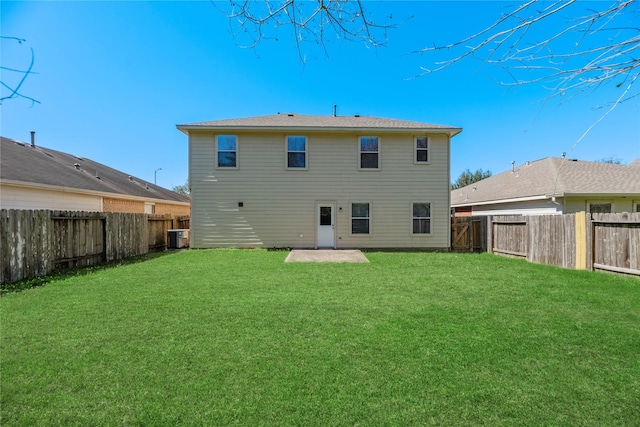 back of property featuring a yard, cooling unit, and a fenced backyard