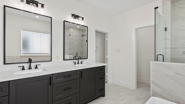 bathroom with double vanity, a stall shower, marble finish floor, and a sink