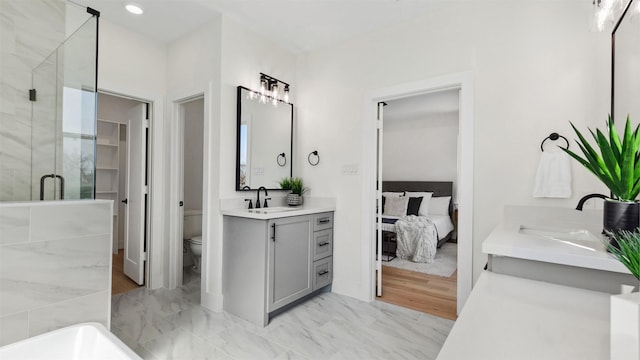 bathroom with vanity, recessed lighting, a shower stall, toilet, and marble finish floor