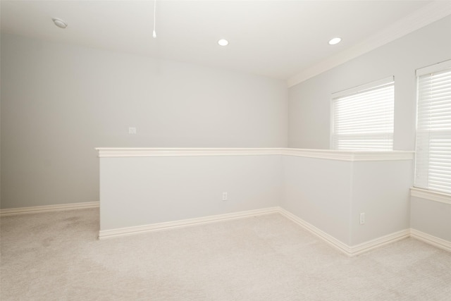 spare room with recessed lighting, light carpet, and baseboards