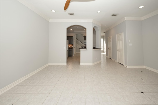 unfurnished room featuring visible vents, a ceiling fan, and ornamental molding