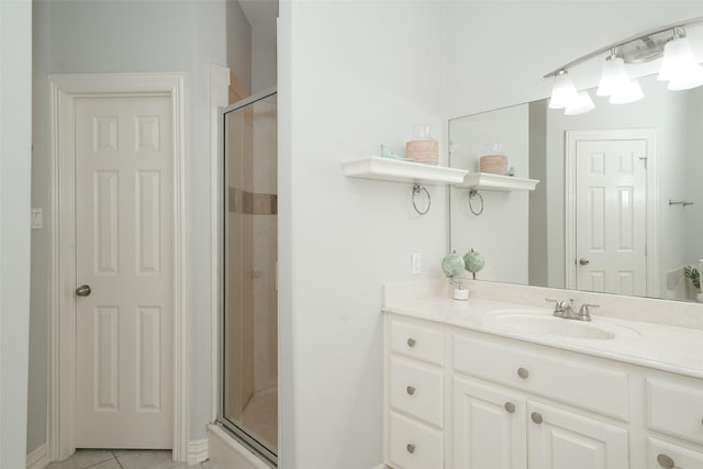 bathroom featuring a stall shower, tile patterned flooring, and vanity