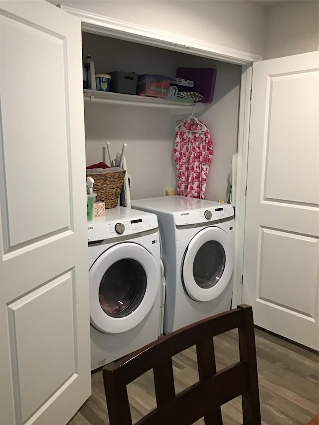 laundry room with washer and dryer, laundry area, and wood finished floors