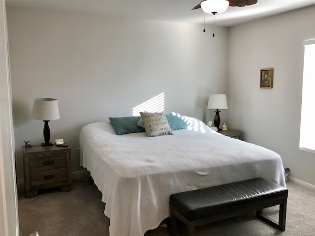 bedroom with ceiling fan, carpet, and baseboards