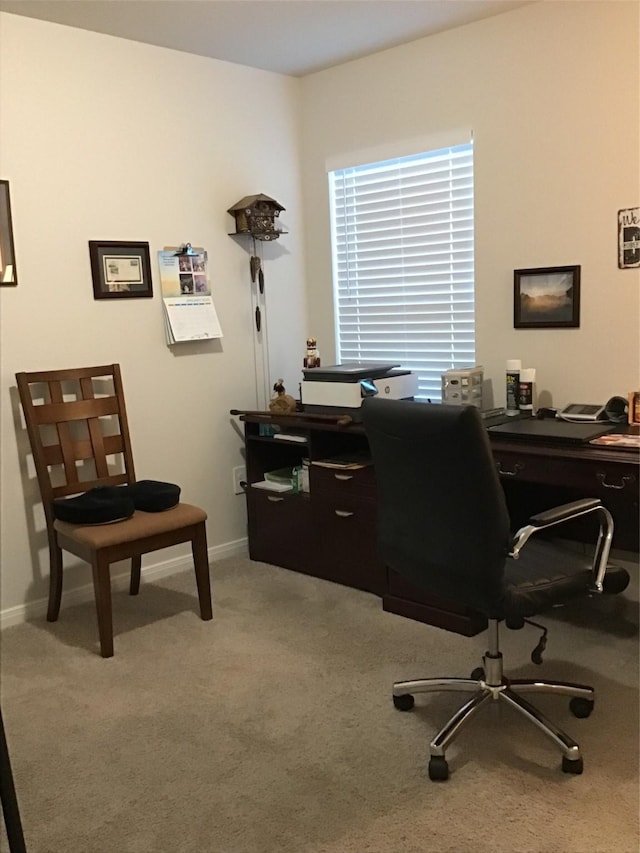 carpeted office featuring baseboards