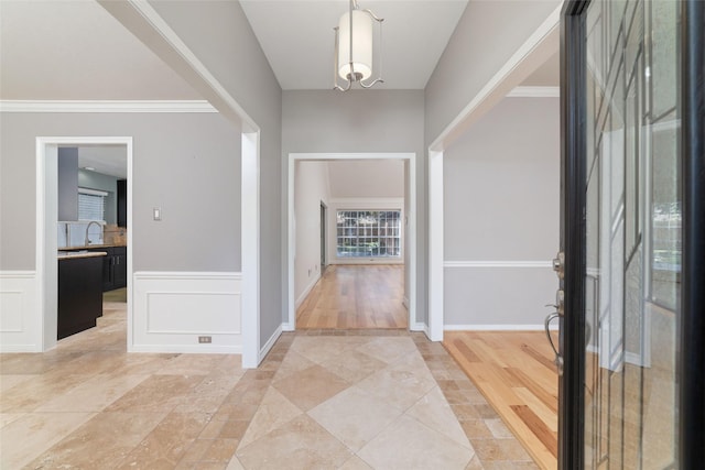 foyer entrance featuring wainscoting and a decorative wall