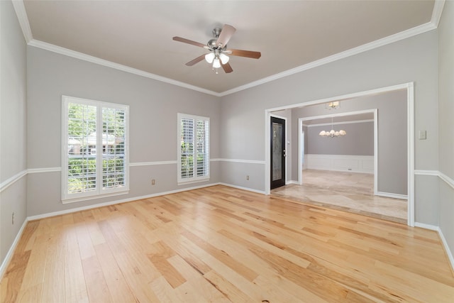 empty room with light wood-type flooring, baseboards, ornamental molding, and ceiling fan with notable chandelier