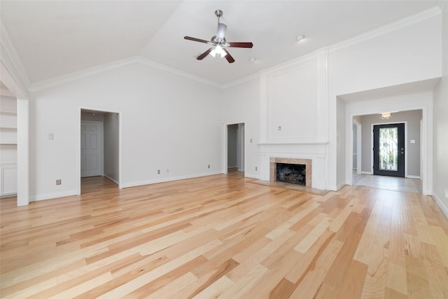 unfurnished living room with baseboards, a tile fireplace, ceiling fan, light wood-type flooring, and high vaulted ceiling