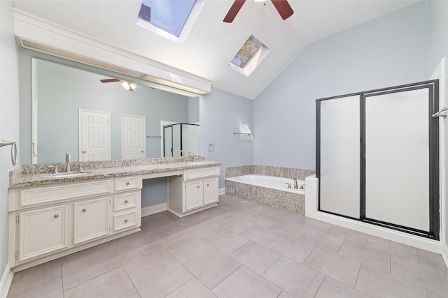 full bath with lofted ceiling with skylight, a stall shower, ceiling fan, vanity, and a bath