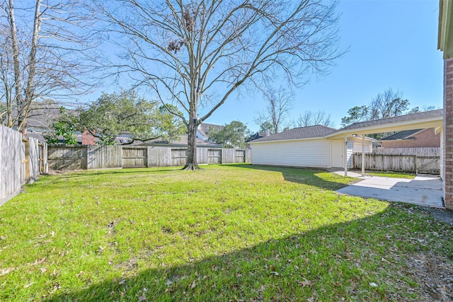 view of yard with a patio area, a fenced backyard, and an outdoor structure