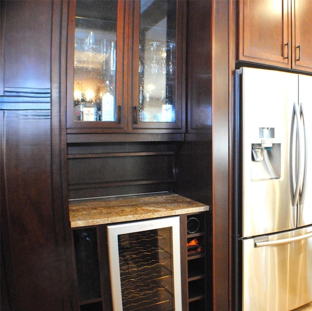 kitchen with beverage cooler, glass insert cabinets, and stainless steel fridge with ice dispenser