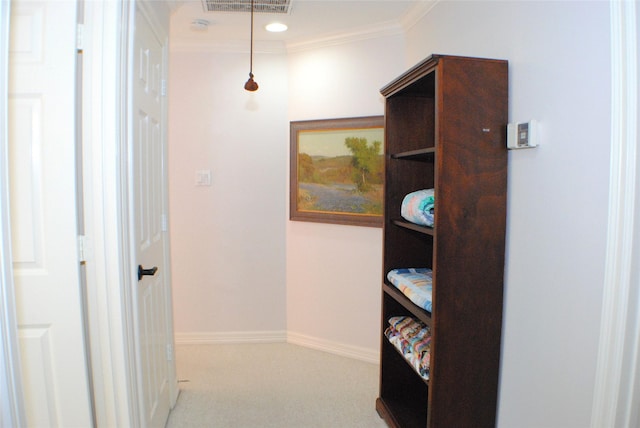 hall featuring carpet flooring, visible vents, baseboards, and ornamental molding