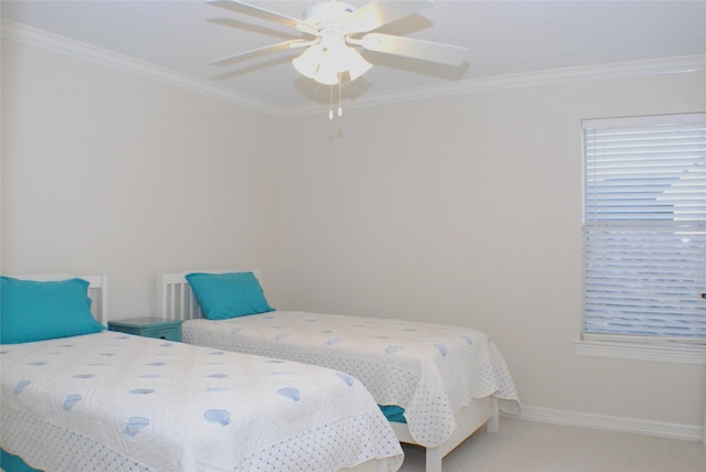 bedroom with baseboards, crown molding, carpet, and a ceiling fan