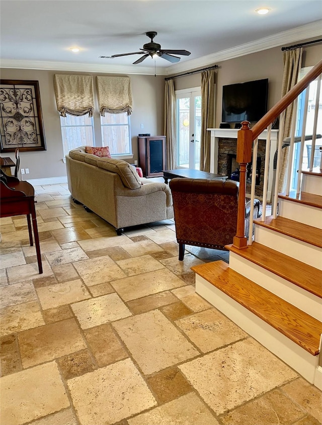 living room featuring stairs, stone tile flooring, ornamental molding, and a fireplace