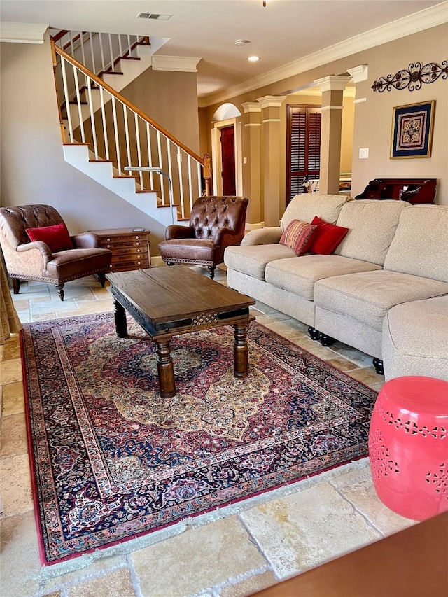 living room with visible vents, stone tile flooring, crown molding, stairs, and ornate columns