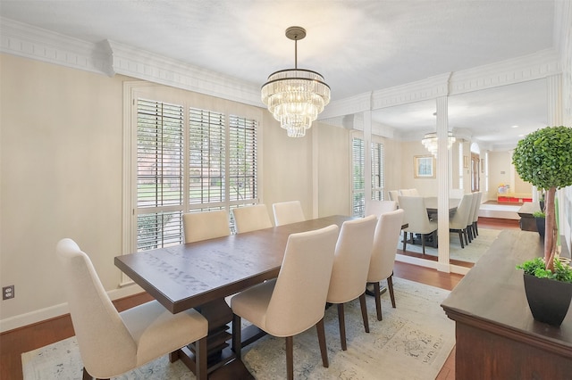 dining space featuring a chandelier, wood finished floors, and ornamental molding