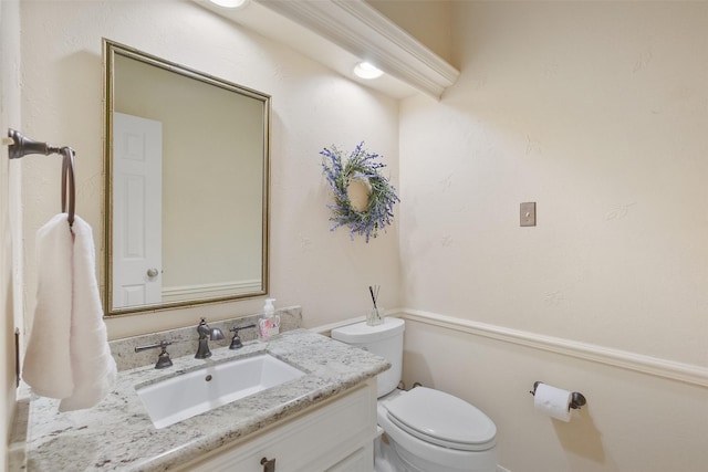 half bathroom with toilet and vanity