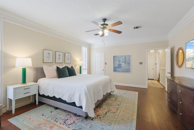 bedroom featuring baseboards, visible vents, dark wood finished floors, a ceiling fan, and ornamental molding