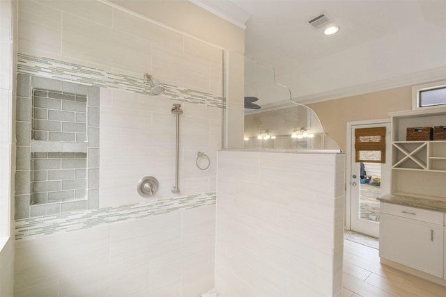 bathroom with ornamental molding, walk in shower, visible vents, and recessed lighting