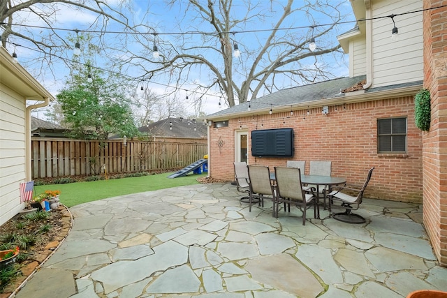 view of patio featuring outdoor dining area and fence