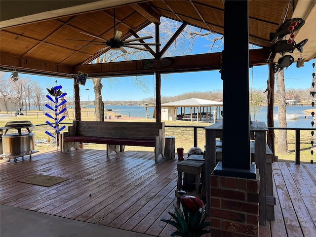 wooden terrace featuring a gazebo, a water view, and ceiling fan