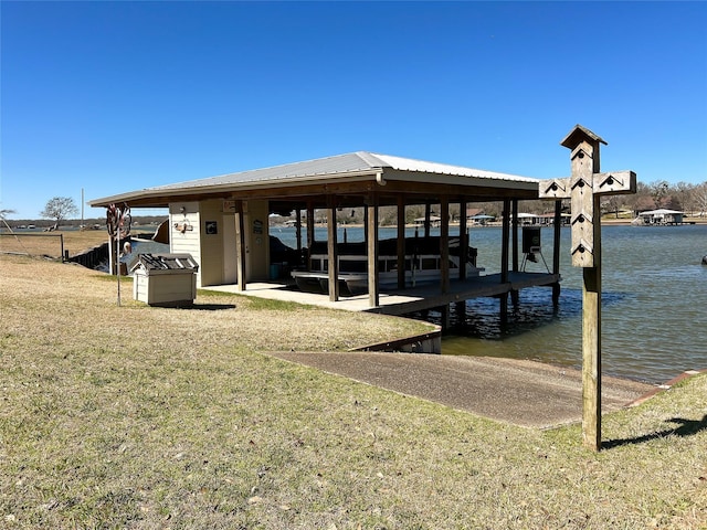 view of dock with a yard and a water view